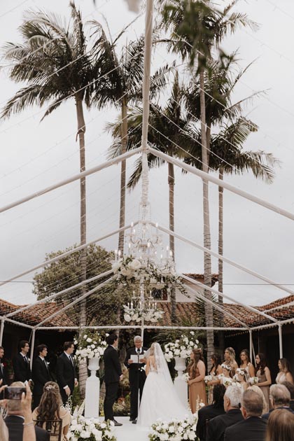 Casa Romantica outdoor wedding ceremony with chic chandeliers decorated with white blooms