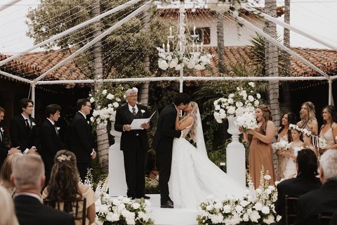 Bride and groom share their first kiss at their Casa Romantica wedding reception