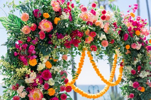 Floral wedding arch with marigolds and bright blooms