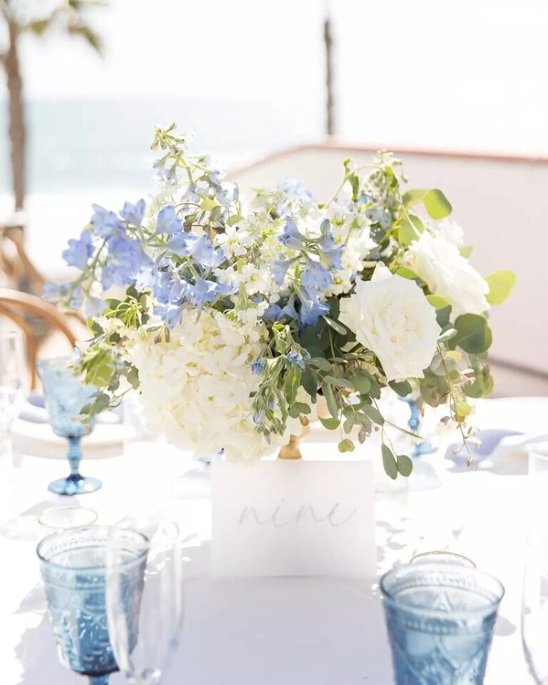 Romantic blue and white floral designs at a Ole Hanson Beach Club wedding reception.