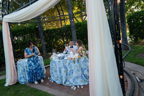 Minimalist florals with drapery around a sweetheart table at Muckenthaler Mansion